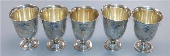 A set of five Persian engraved white metal stem cups, 486 grams.